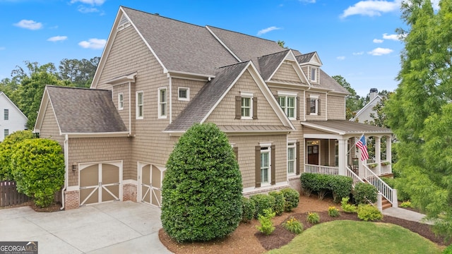 4530 Westgate Dr, Cumming, GA 30040 - shingle-style home with driveway, a shingled roof, covered porch, and an attached garage