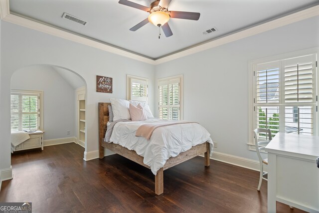 4530 Westgate Dr, Cumming, GA 30040 - bedroom featuring dark wood-type flooring, ornamental molding, arched walkways, and a ceiling fan