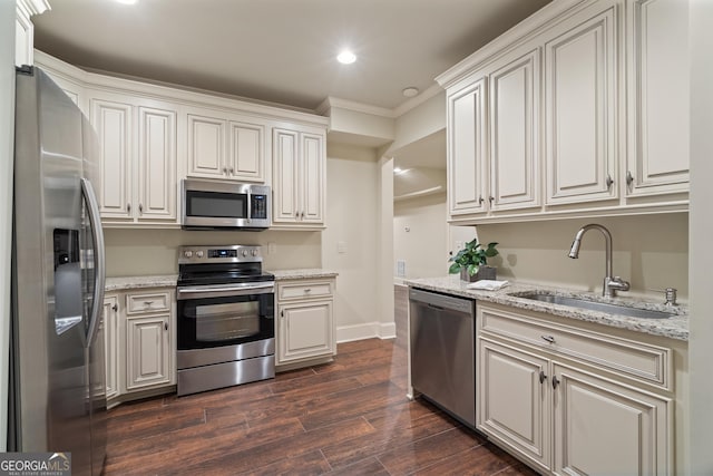 4530 Westgate Dr, Cumming, GA 30040 - kitchen featuring appliances with stainless steel finishes, recessed lighting, dark wood finished floors, crown molding, and light stone countertops