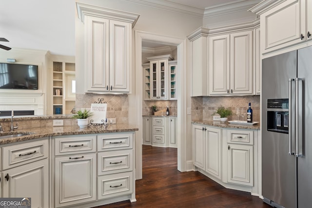 4530 Westgate Dr, Cumming, GA 30040 - kitchen with high quality fridge, light stone countertops, tasteful backsplash, ornamental molding, and dark wood-style floors