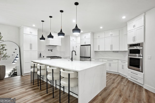 194 Branch Valley Way, Dallas, GA 30132 - kitchen featuring appliances with stainless steel finishes, light wood-type flooring, recessed lighting, decorative backsplash, and white cabinetry