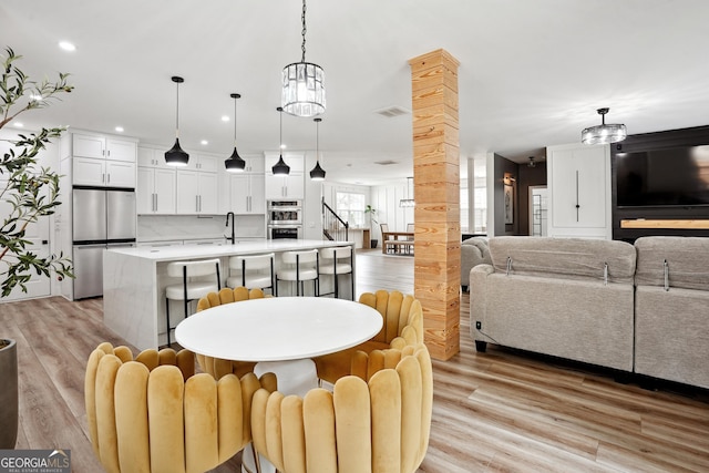 194 Branch Valley Way, Dallas, GA 30132 - dining space featuring light wood-type flooring, recessed lighting, a chandelier, and ornate columns
