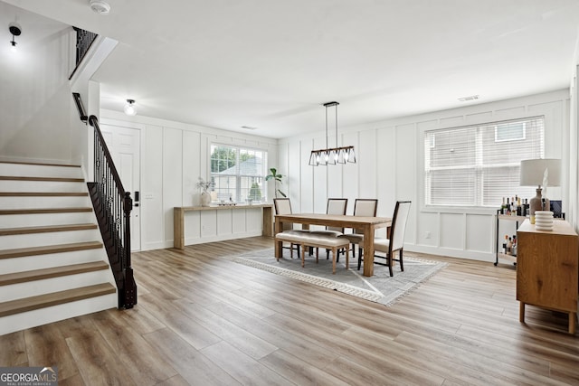 194 Branch Valley Way, Dallas, GA 30132 - dining area featuring a decorative wall, light wood-style flooring, and stairs