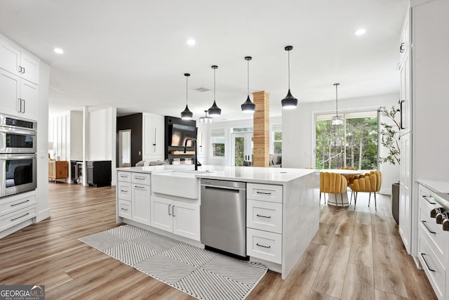 194 Branch Valley Way, Dallas, GA 30132 - kitchen featuring stainless steel appliances, open floor plan, light wood-type flooring, white cabinets, and light countertops