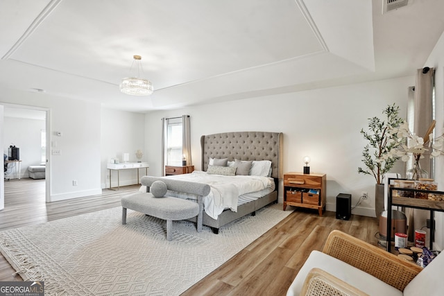 194 Branch Valley Way, Dallas, GA 30132 - bedroom featuring a tray ceiling, wood finished floors, and a chandelier