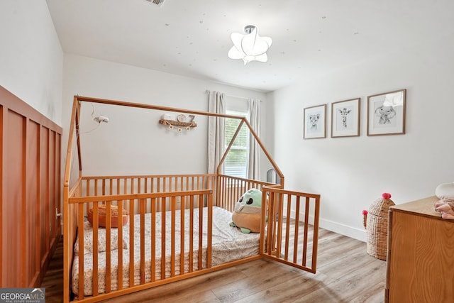 194 Branch Valley Way, Dallas, GA 30132 - bedroom featuring wood finished floors and a nursery area