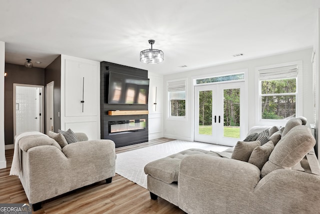 194 Branch Valley Way, Dallas, GA 30132 - living room with a large fireplace, light wood finished floors, and french doors