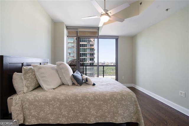 270 17th St NW Unit 2210, Atlanta, GA 30363 - bedroom featuring dark wood-type flooring, expansive windows, and a ceiling fan