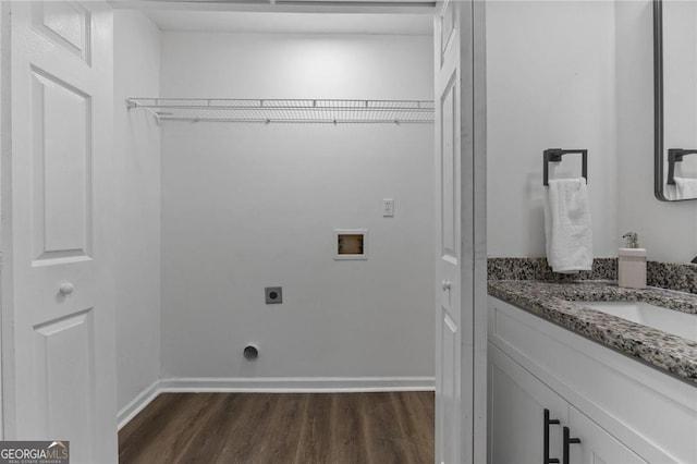 9404 Cypress Ln, Jonesboro, GA 30238 - washroom featuring washer hookup, electric dryer hookup, dark wood-style flooring, and baseboards