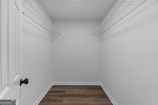 9404 Cypress Ln, Jonesboro, GA 30238 - walk in closet with dark wood-style flooring