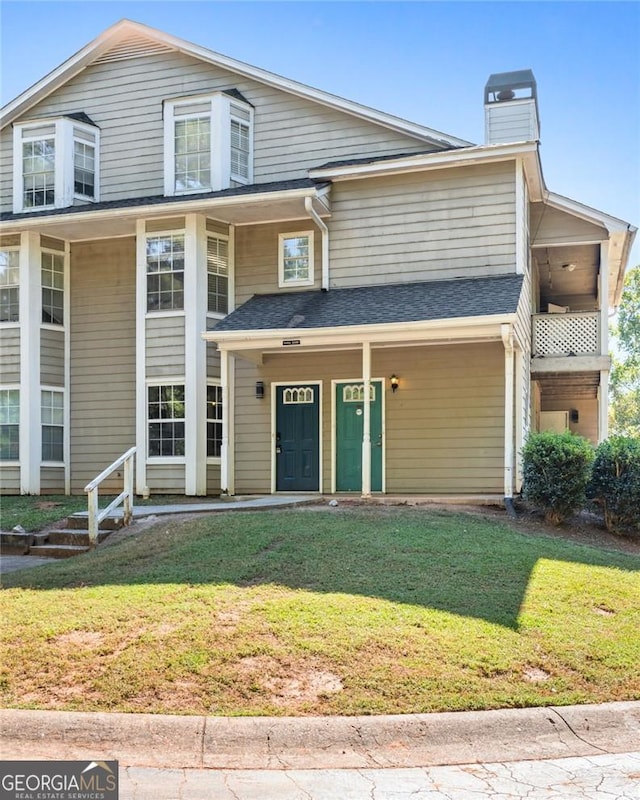 9404 Cypress Ln, Jonesboro, GA 30238 - view of front of home with a chimney, a front lawn, and a porch