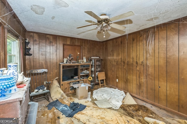 205 Elm St, Washington, GA 30673 - bedroom featuring wooden walls, a textured ceiling, and a ceiling fan