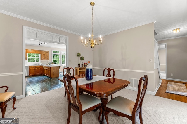 607 Lees Mill Rd, Fayetteville, GA 30214 - dining area with a chandelier, crown molding, baseboards, and dark colored carpet