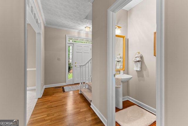 607 Lees Mill Rd, Fayetteville, GA 30214 - foyer featuring baseboards, light wood-style flooring, crown molding, and a textured ceiling