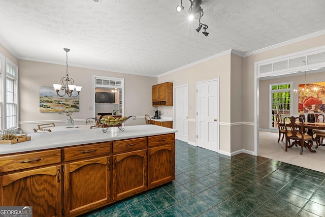 607 Lees Mill Rd, Fayetteville, GA 30214 - kitchen with a chandelier, brown cabinets, light countertops, crown molding, and a textured ceiling