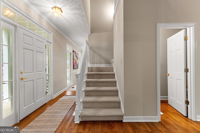 607 Lees Mill Rd, Fayetteville, GA 30214 - foyer entrance with crown molding, wood finished floors, baseboards, and stairs