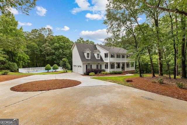 607 Lees Mill Rd, Fayetteville, GA 30214 - view of front of house with covered porch, driveway, an attached garage, and a swimming pool