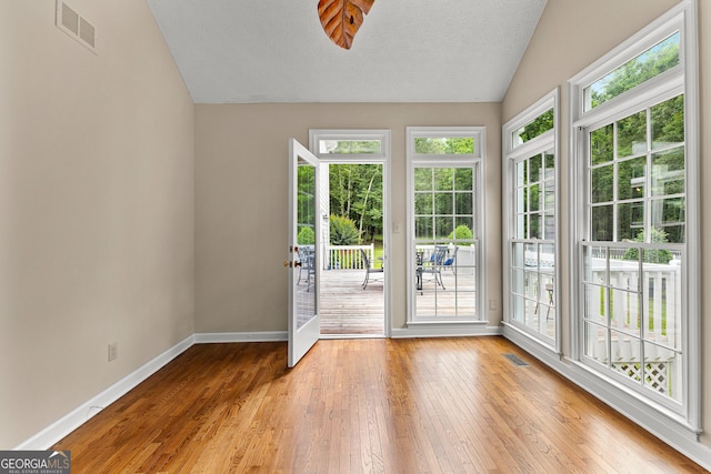 607 Lees Mill Rd, Fayetteville, GA 30214 - doorway featuring lofted ceiling, baseboards, wood-type flooring, and a textured ceiling