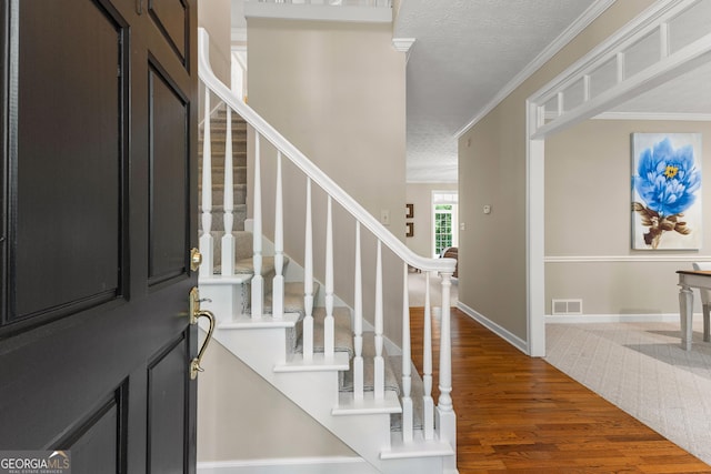 607 Lees Mill Rd, Fayetteville, GA 30214 - foyer entrance featuring wood finished floors, a textured ceiling, stairway, ornamental molding, and baseboards