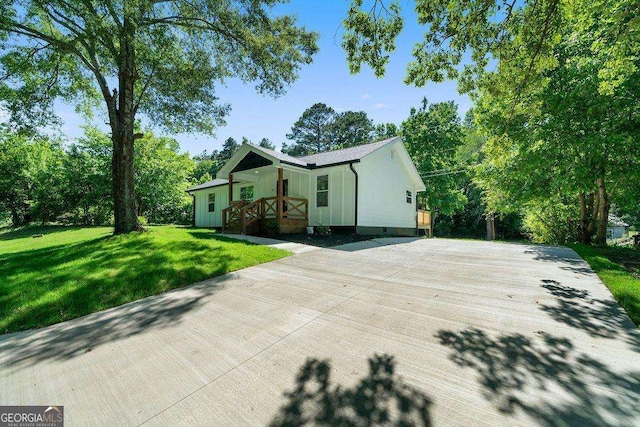 6 W Point Dr SE, Lindale, GA 30147 - view of front of property with a front yard, covered porch, and board and batten siding