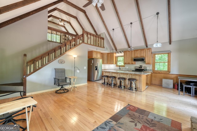 224 Shake Rag Rd, Hiawassee, GA 30546 - living room with high vaulted ceiling, light wood-style flooring, beam ceiling, a ceiling fan, and stairs