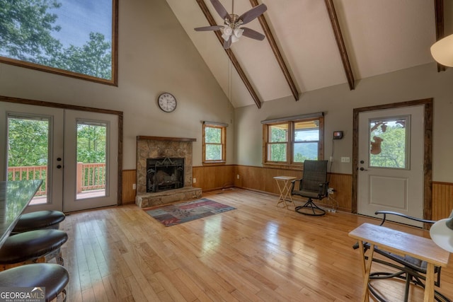 224 Shake Rag Rd, Hiawassee, GA 30546 - living area featuring high vaulted ceiling, wainscoting, light wood-type flooring, a fireplace, and beam ceiling