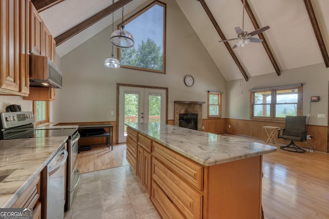 224 Shake Rag Rd, Hiawassee, GA 30546 - kitchen featuring stainless steel appliances, high vaulted ceiling, wainscoting, a fireplace, and light stone countertops