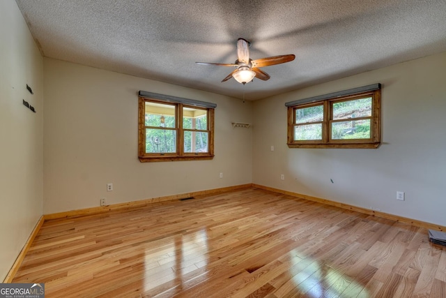 224 Shake Rag Rd, Hiawassee, GA 30546 - spare room with healthy amount of natural light, ceiling fan, light wood-style floors, a textured ceiling, and baseboards
