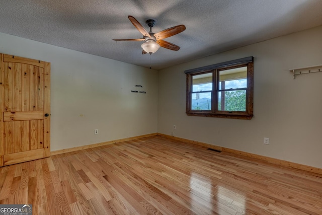 224 Shake Rag Rd, Hiawassee, GA 30546 - unfurnished room with a ceiling fan, light wood-style flooring, a textured ceiling, and baseboards