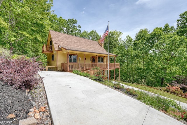 224 Shake Rag Rd, Hiawassee, GA 30546 - rustic home featuring covered porch, driveway, a shingled roof, and a balcony
