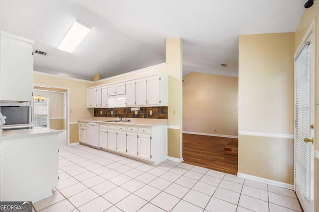 467 Ravinia Way, Lawrenceville, GA 30044 - kitchen with light countertops, light tile patterned floors, vaulted ceiling, white cabinets, and decorative backsplash