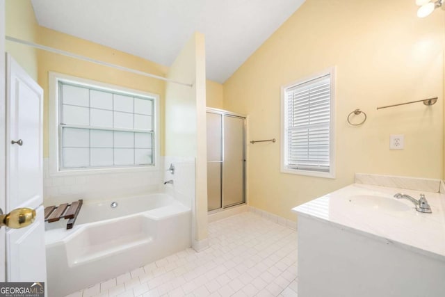 467 Ravinia Way, Lawrenceville, GA 30044 - bathroom with lofted ceiling, a garden tub, a stall shower, tile patterned floors, and healthy amount of natural light