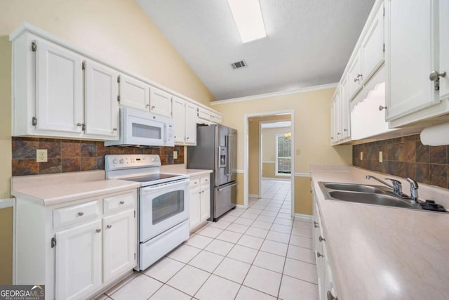 467 Ravinia Way, Lawrenceville, GA 30044 - kitchen with white appliances, a sink, white cabinets, lofted ceiling, and light tile patterned floors