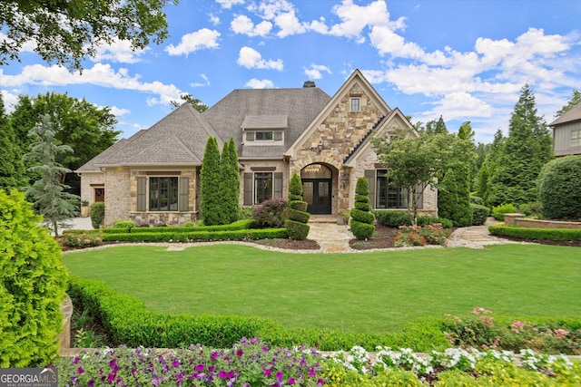 3057 Watsons Bnd, Milton, GA 30004 - view of front of home featuring stone siding, a front lawn, a chimney, and roof with shingles