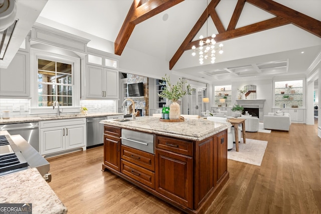 3057 Watsons Bnd, Milton, GA 30004 - kitchen featuring a fireplace, a warming drawer, stainless steel dishwasher, and tasteful backsplash