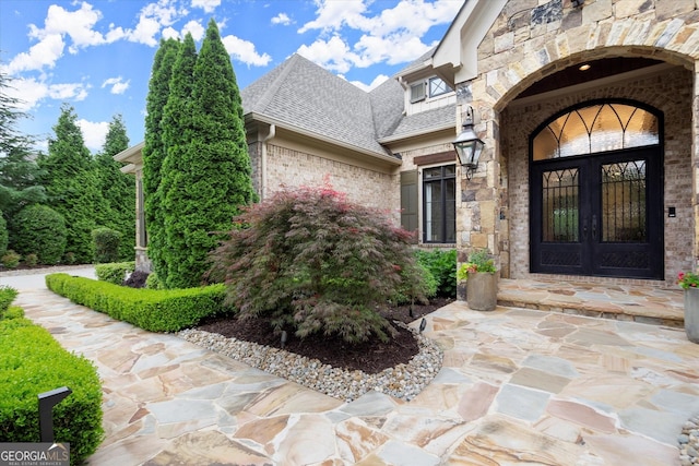 3057 Watsons Bnd, Milton, GA 30004 - entrance to property with french doors, brick siding, roof with shingles, and stone siding