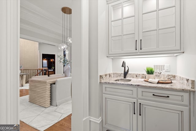 3057 Watsons Bnd, Milton, GA 30004 - indoor wet bar featuring crown molding, hanging light fixtures, and wood finished floors
