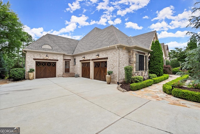 3057 Watsons Bnd, Milton, GA 30004 - view of front of home with an attached garage, concrete driveway, a shingled roof, and stone siding