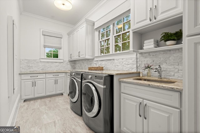 3057 Watsons Bnd, Milton, GA 30004 - washroom with cabinet space, washing machine and clothes dryer, crown molding, bar with sink, and light marble finish floors