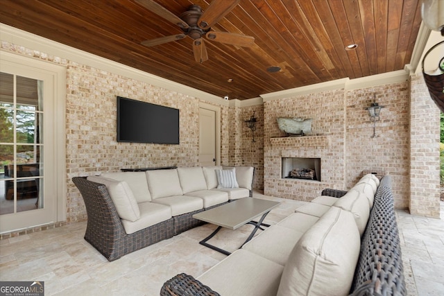 3057 Watsons Bnd, Milton, GA 30004 - living room featuring brick wall, stone tile floors, wood ceiling, ornamental molding, and ceiling fan