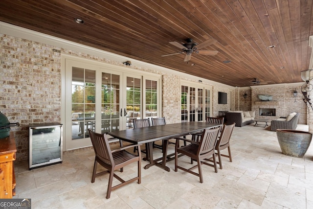 3057 Watsons Bnd, Milton, GA 30004 - view of patio / terrace with french doors, wine cooler, a ceiling fan, an outdoor living space with a fireplace, and outdoor dining area
