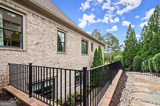 3057 Watsons Bnd, Milton, GA 30004 - view of side of home with brick siding, a shingled roof, and a fenced backyard
