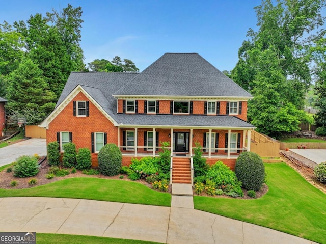 2535 Winthrope Way, Lawrenceville, GA 30044 - view of front of home featuring brick siding, covered porch, a front yard, and a shingled roof
