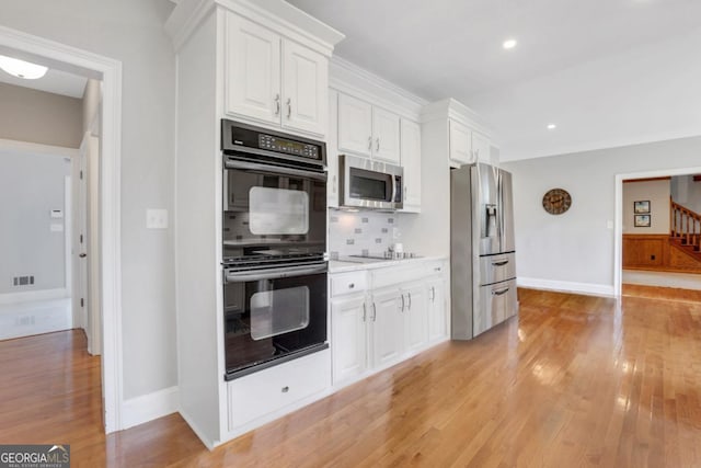 2535 Winthrope Way, Lawrenceville, GA 30044 - kitchen featuring black appliances, light wood-style floors, backsplash, white cabinetry, and baseboards