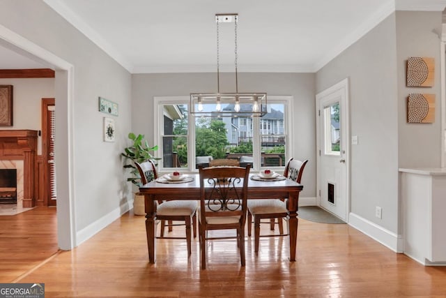 2535 Winthrope Way, Lawrenceville, GA 30044 - dining area featuring light wood finished floors, baseboards, crown molding, and a fireplace