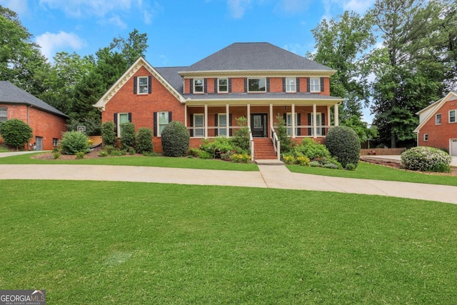 2535 Winthrope Way, Lawrenceville, GA 30044 - colonial inspired home with brick siding, a front lawn, and covered porch