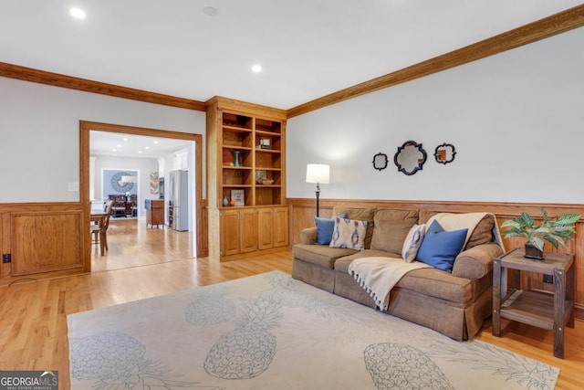 2535 Winthrope Way, Lawrenceville, GA 30044 - living area with crown molding, a wainscoted wall, light wood-type flooring, recessed lighting, and wood walls