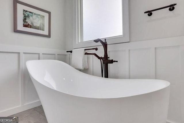 2535 Winthrope Way, Lawrenceville, GA 30044 - full bath with a decorative wall, wainscoting, and a freestanding tub