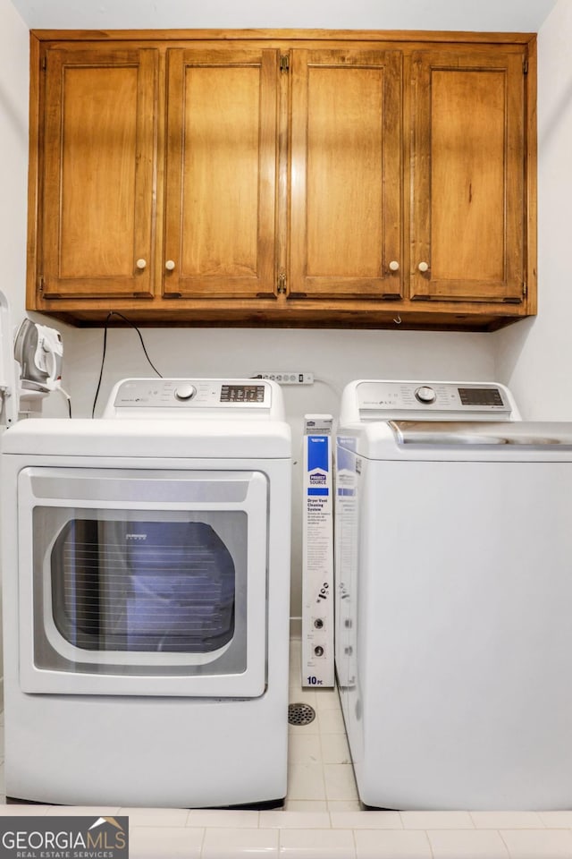 2535 Winthrope Way, Lawrenceville, GA 30044 - laundry room with washer and dryer, cabinet space, and light tile patterned floors
