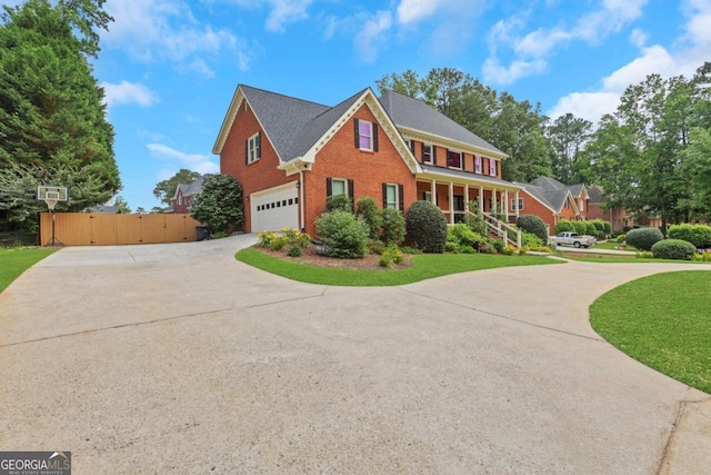 2535 Winthrope Way, Lawrenceville, GA 30044 - view of front of home with driveway, brick siding, an attached garage, and a gate